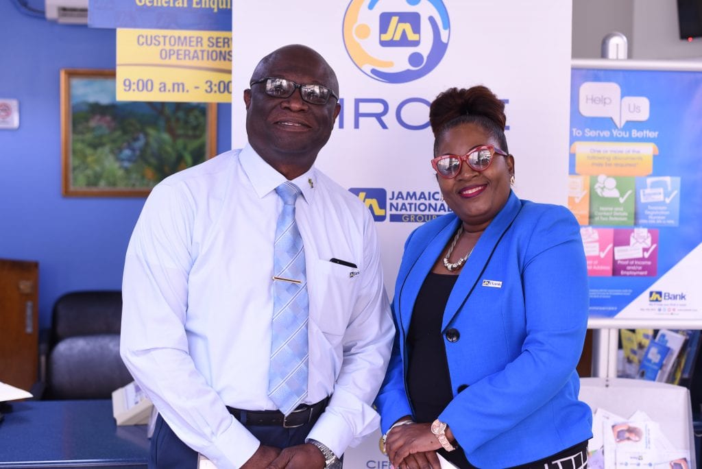 Deputy Superintendent of Police, Conrad Cummings (left) has the attention of Ripton Gordon, JN member. Meanwhile Canute Simpson, business relationship and sales manager, JN Bank, Savanna-La-Mar and Lucea looks on.